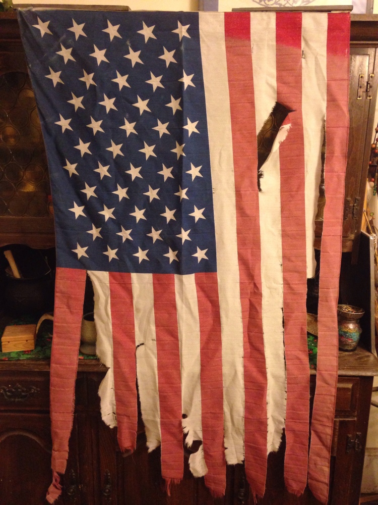 a polyester American flag, tattered by the elements